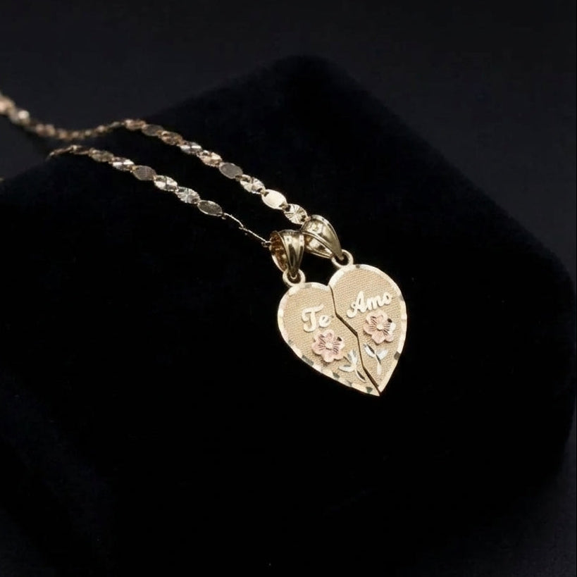 Gold necklace with heart-shaped pendants on a black background